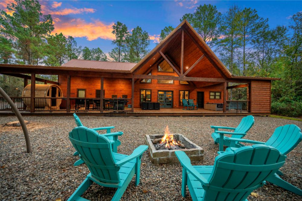 The beautifully lit backyard at twilight offers the perfect setting for outdoor dining, relaxation, and family fun.