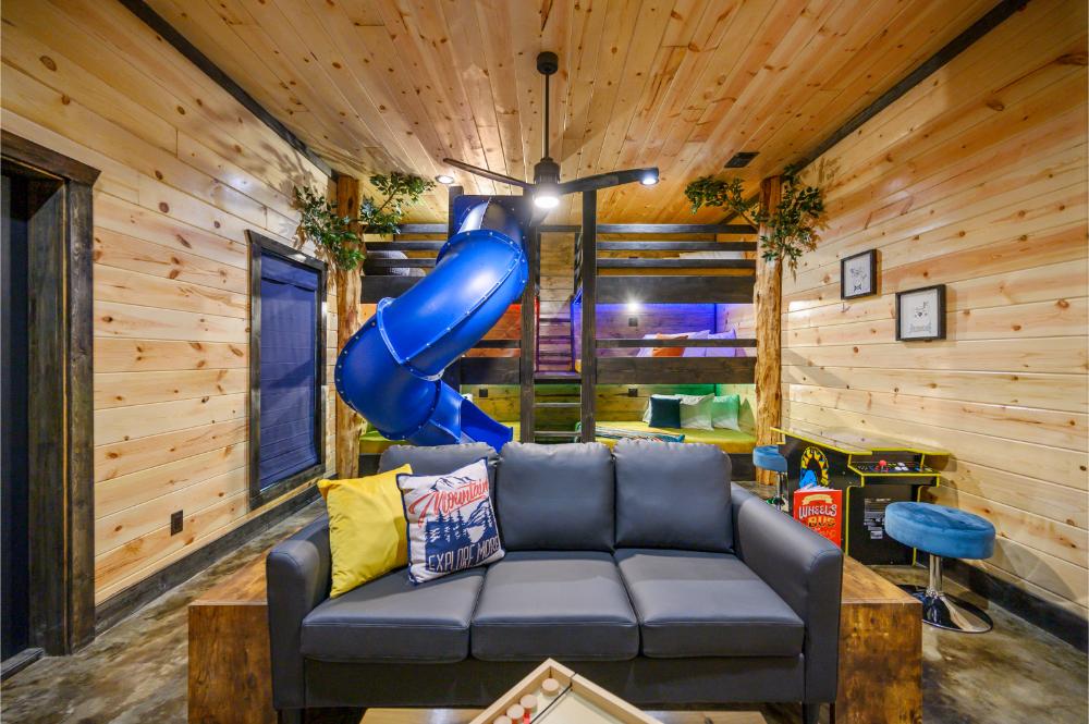 Slide into adventure—this treehouse bunk room is a dream come true for kids! 