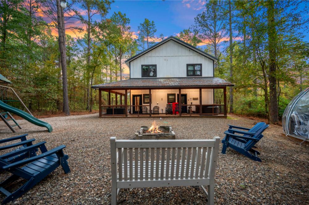The inviting outdoor space features a cozy hot tub and unique hypedome, perfect for relaxing under the stars.