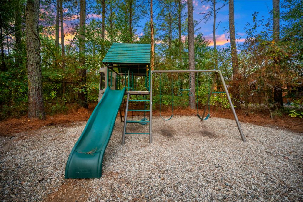 Kids will love the backyard playground, complete with swings and a slide for endless outdoor fun.
