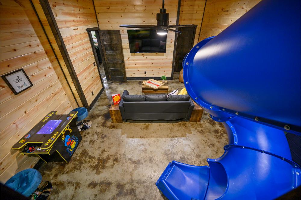 A fun and inviting loft view overlooking the cozy living space, complete with a playful indoor slide for all ages.