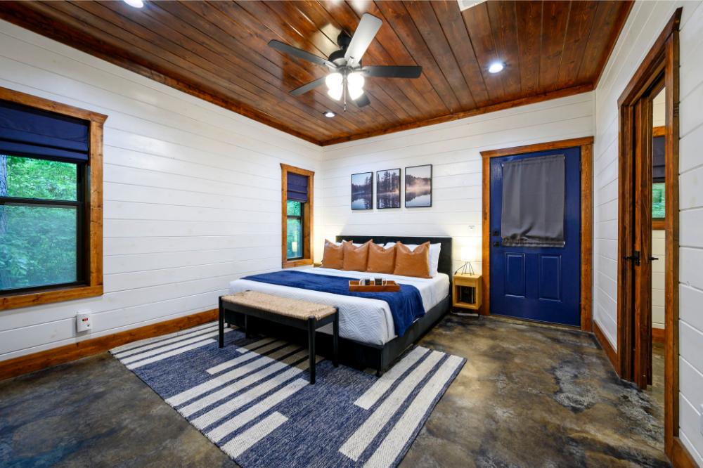 This spacious master suite features a king bed, comfortable linens, and a private bathroom.