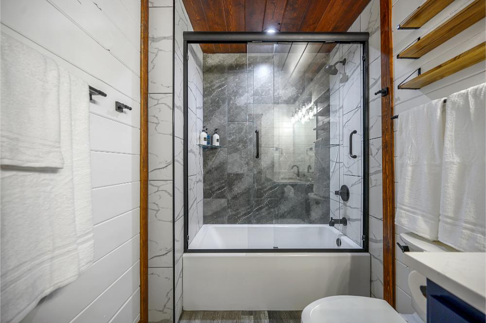 Unwind with a soak or rinse in this tiled tub and shower combination.