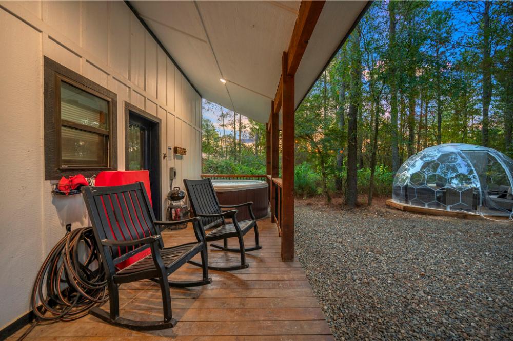 Enjoy outdoor games and a covered deck that adds comfort and fun to the backyard space.