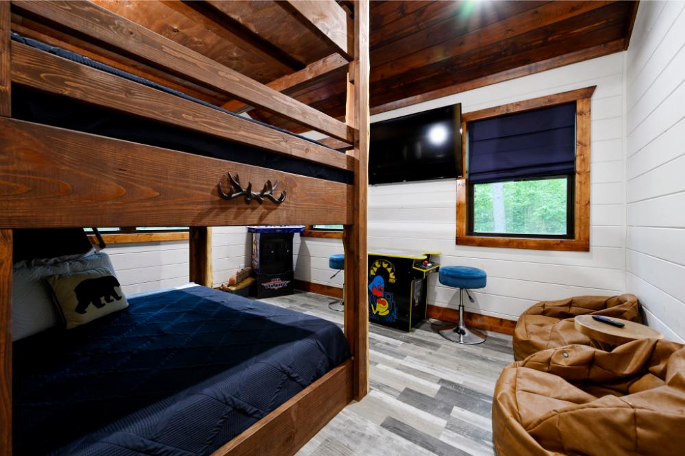 This forest-themed bunk room offers a cozy space for kids to sleep, play, and relax.